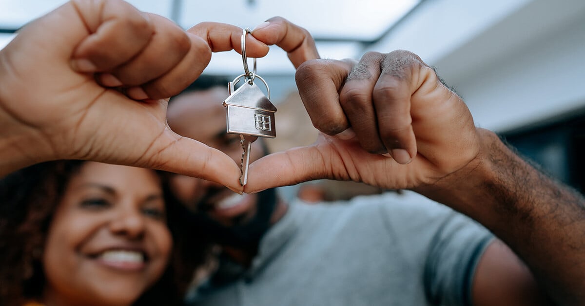 Happy couple holding key to home