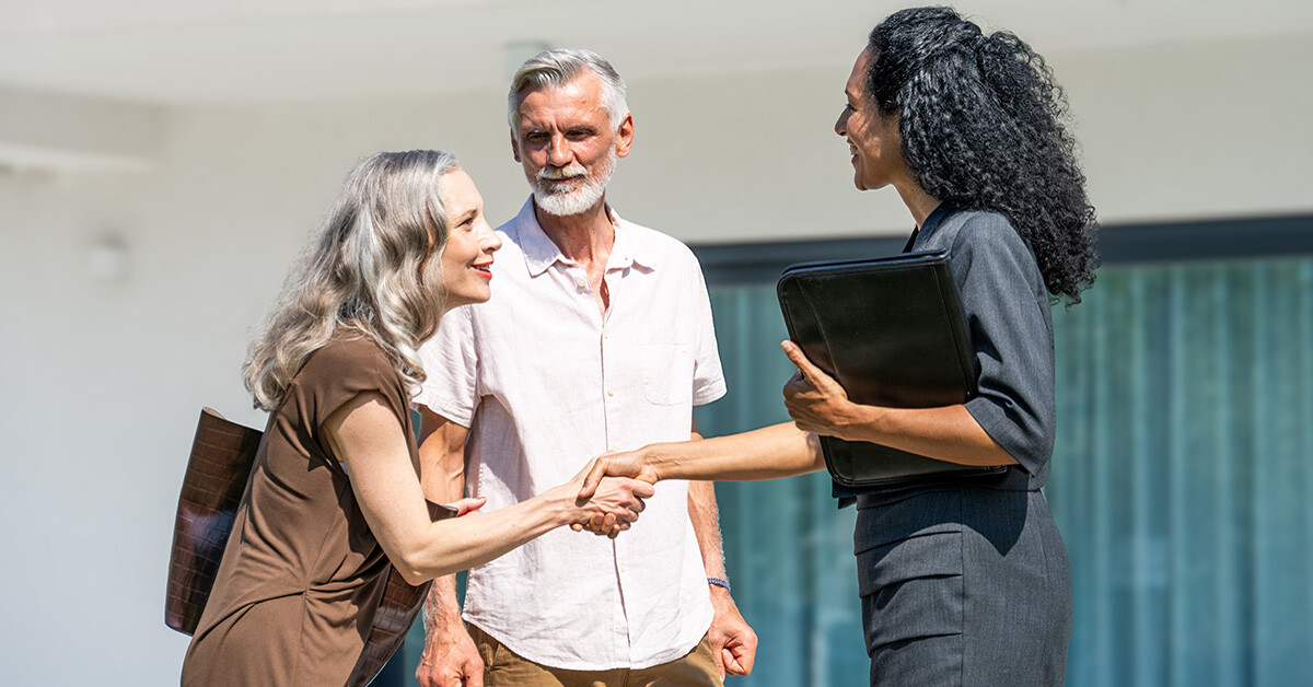 Real estate agent with clients during summer